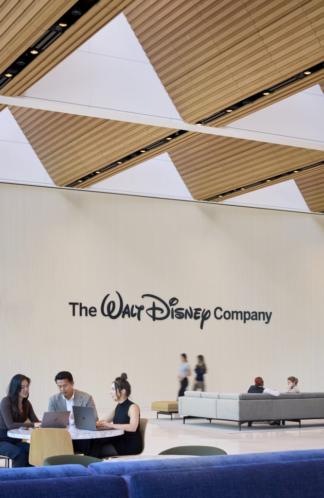 Employees in the Great Room with The Walt Disney Company logo displayed on the wall by Dave Burk &ndash; SOM &copy; 2024 Disney